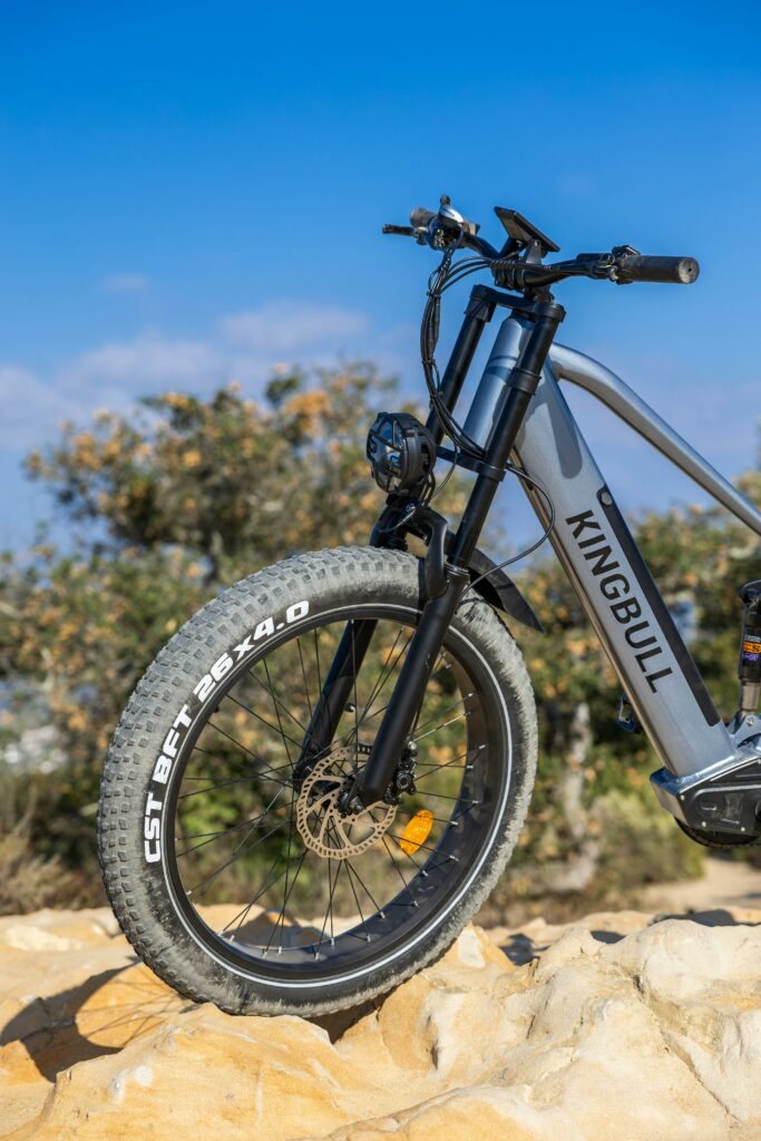 A modern electric mountain bike with thick tires on rocky terrain, showcasing outdoor adventure potential.