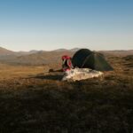 Tent and backpack in scenic Jämtlands mountains during summer. Perfect for adventure enthusiasts.